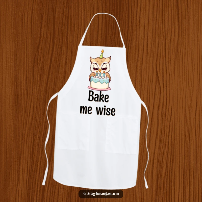 Funny apron with a curious owl character examining a birthday cake, ideal for adding whimsical humor to baking and party preparations.