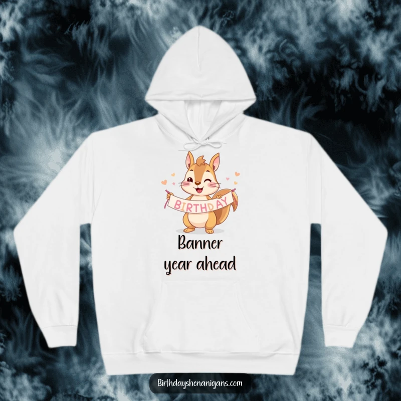 Funny squirrel hoodie showcasing a cheerful character proudly holding a vibrant birthday banner, ready for fun.