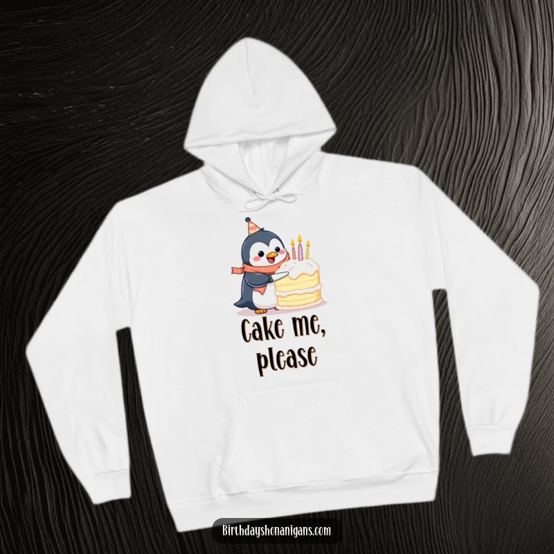 Funny hoodie featuring a happy penguin in a birthday scarf, attempting to tackle a giant cake, embodying celebratory effort and humor.