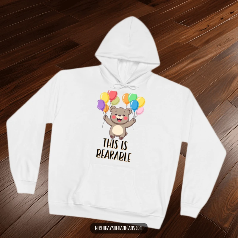 Funny hoodie featuring a cheerful bear with a big smile, juggling colorful balloons, perfect for cozy fun.