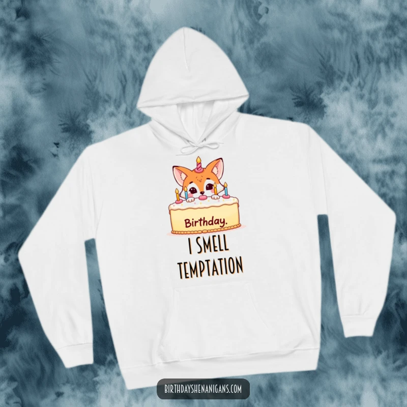 Funny hoodie design of a sneaky fox with a playful grin, hiding behind a beautifully decorated birthday cake.