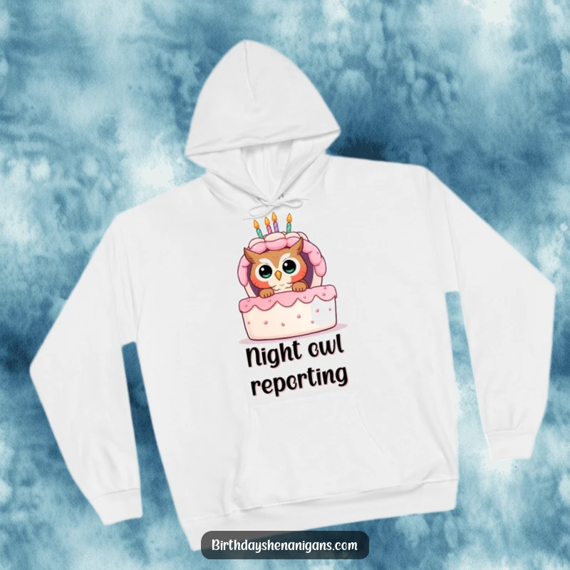 Funny hoodie featuring a curious owl peeking from behind a giant birthday cake, perfect for cozy and inquisitive moments.