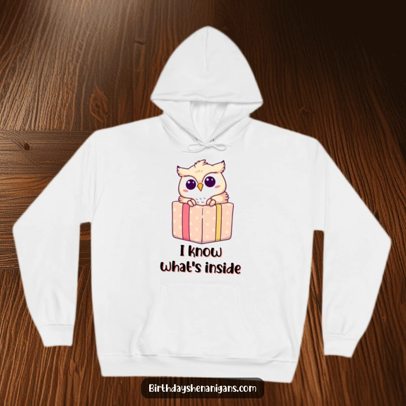 Funny hoodie design with an owl peeking out of a gift box, conveying surprise, joy, and warmth.