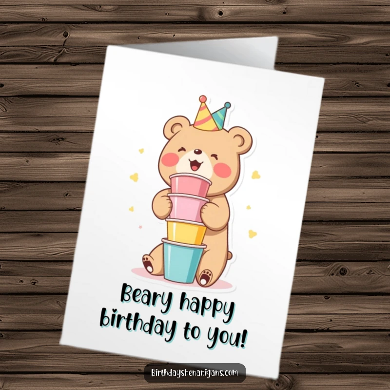 Funny Free Printable Birthday Card: A cute bear gleefully stacks multiple colorful party cups high, ready for a birthday bash.