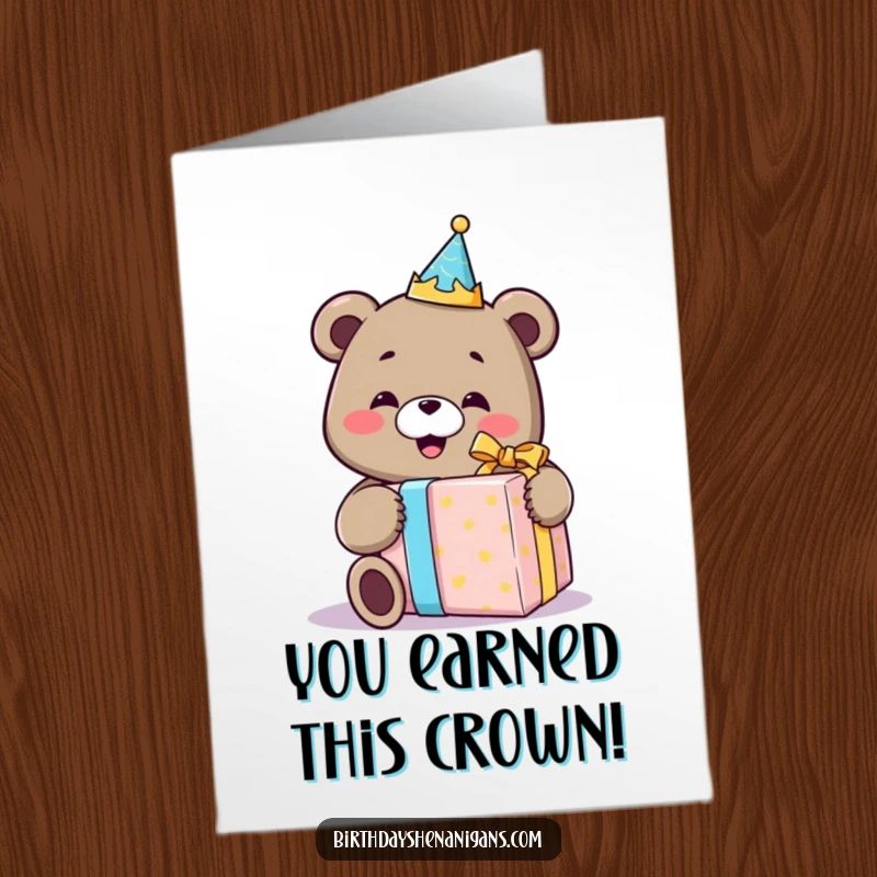 Funny Free Printable Congrats Card: Bear sporting a birthday crown happily opens a comically large gift, symbolizing great success.