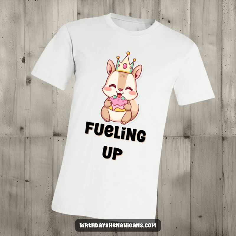 Funny Squirrel T-Shirt: Joyful character with crown stuffs cheeks with cake, a humorous ode to indulgence.