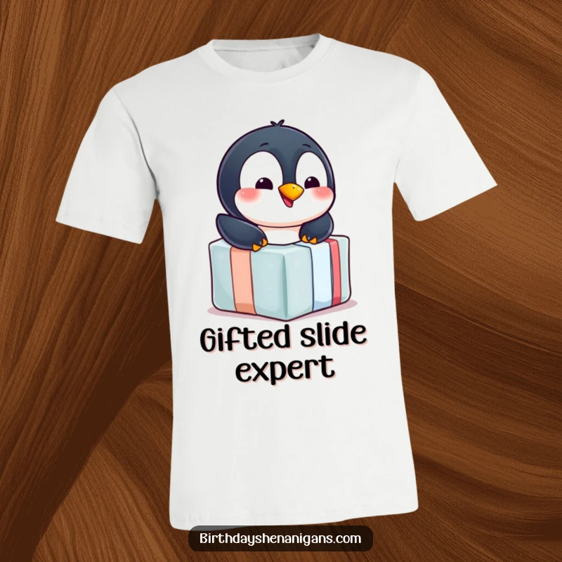 Funny penguin t-shirt, cheerful, sliding down wrapped gift, winter fun, playful, celebration attire, humorous.