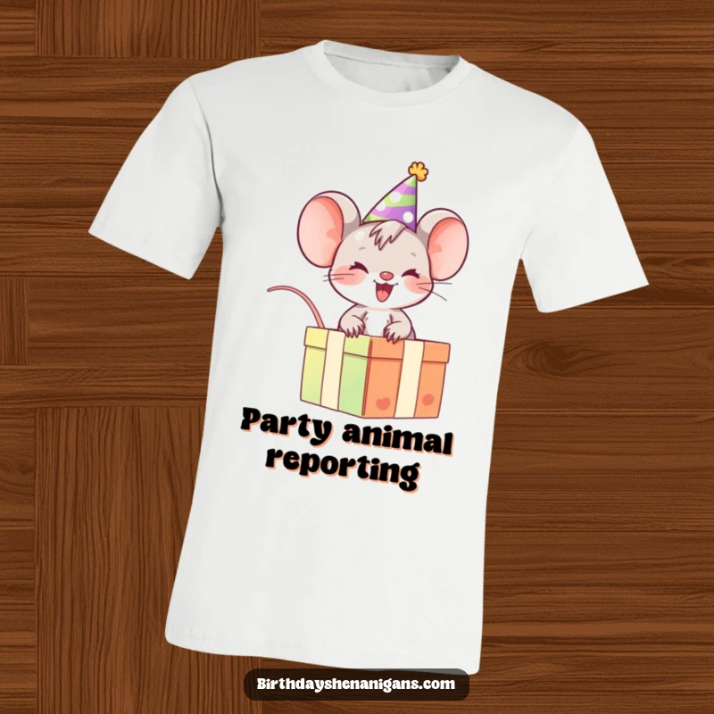 Funny Mouse T-Shirt: Giggling character with party hat rides gift box, a humorous celebration of fun.
