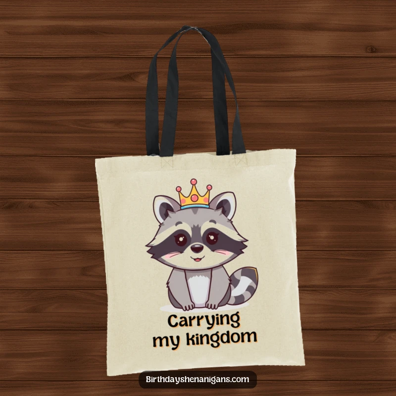 Funny raccoon tote bag designed with a happy character wearing a festive crown, perfect for shopping and events.
